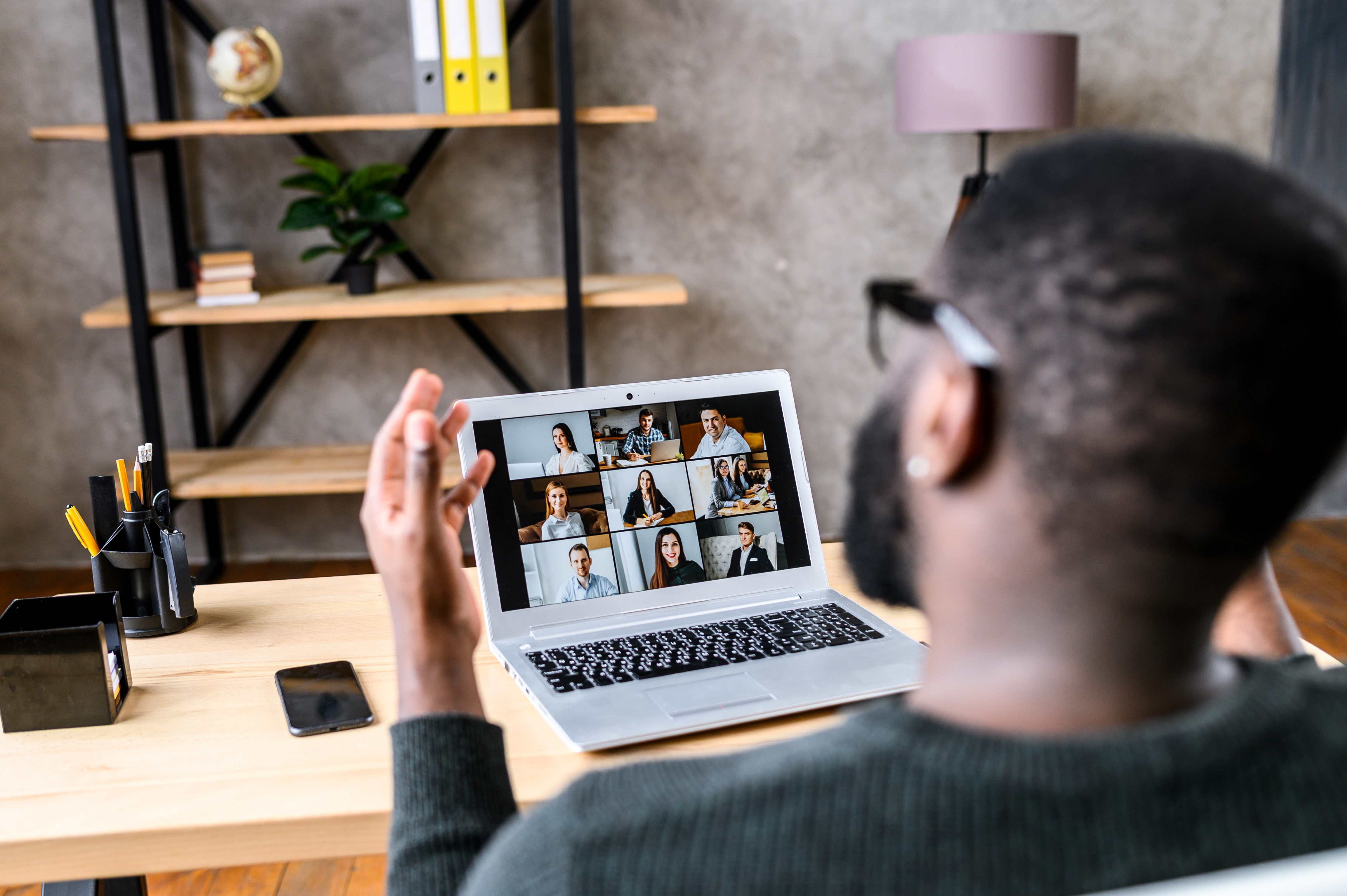 Person attending a virtual meeting on a laptop, highlighting remote work and digital communication