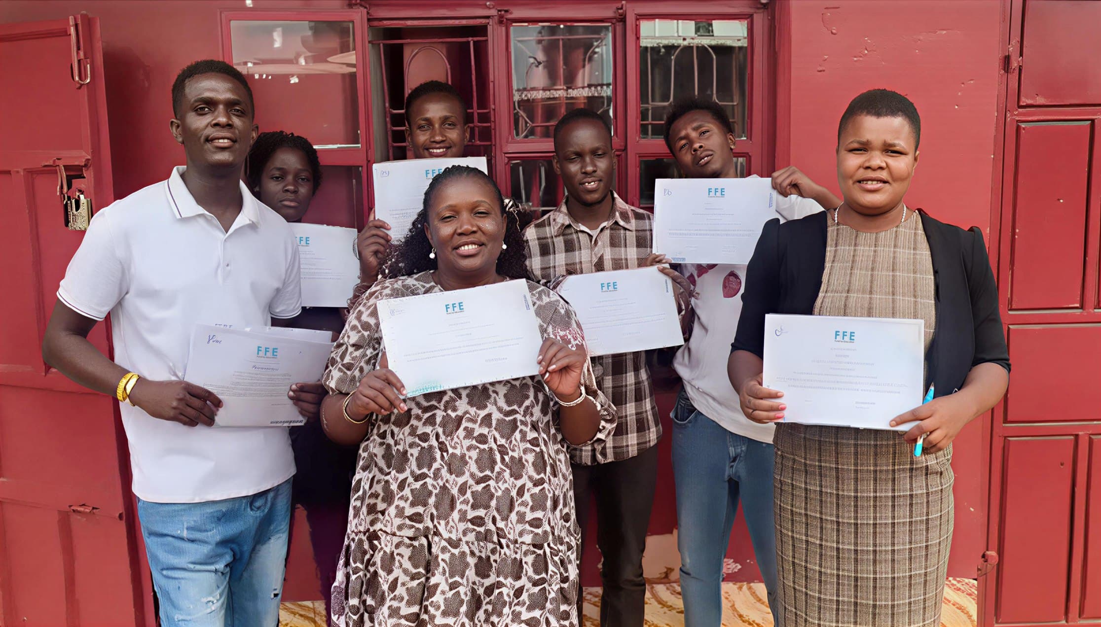 Wezesha Staff and Community Members Holding FFE Certificates