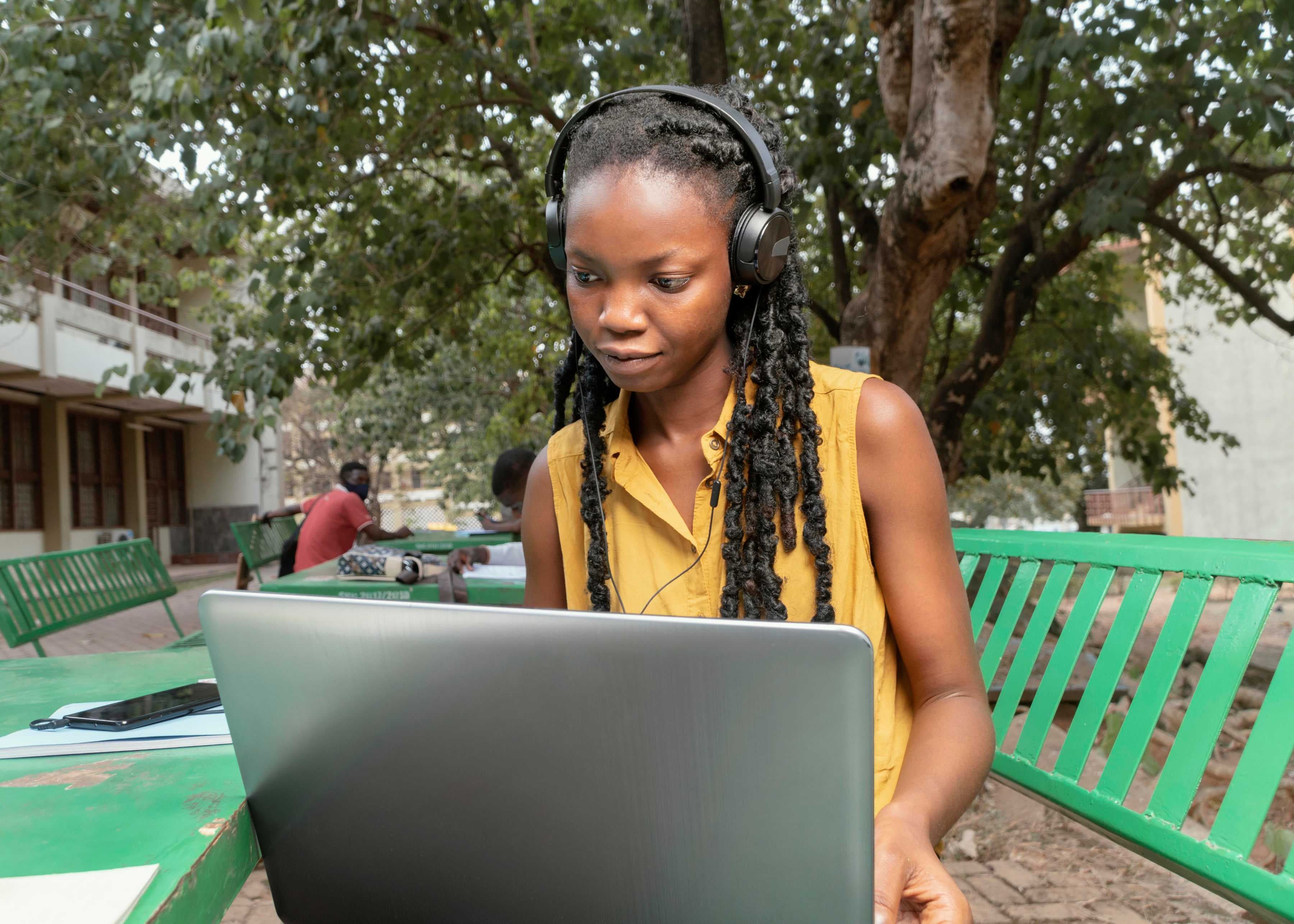 medium-shot-black-woman-studying-with-laptop